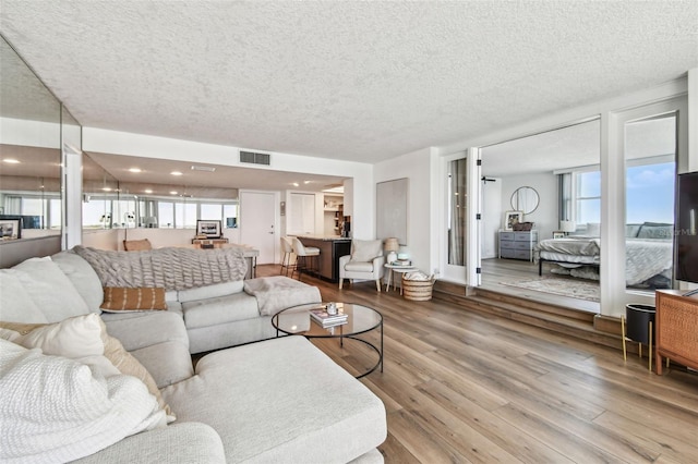 500 Treasure Island Cswy Unit 607, Treasure Island, FL 33706 - living room with healthy amount of natural light, wood finished floors, and a textured ceiling