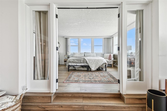 500 Treasure Island Cswy Unit 607, Treasure Island, FL 33706 - bedroom featuring wood finished floors and a textured ceiling