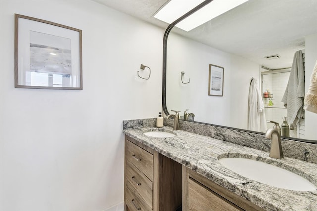 500 Treasure Island Cswy Unit 607, Treasure Island, FL 33706 - bathroom featuring double vanity and a shower stall