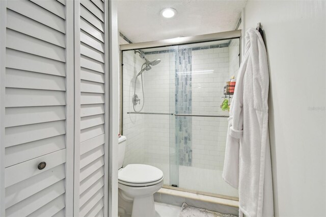 500 Treasure Island Cswy Unit 607, Treasure Island, FL 33706 - full bathroom featuring toilet and a stall shower