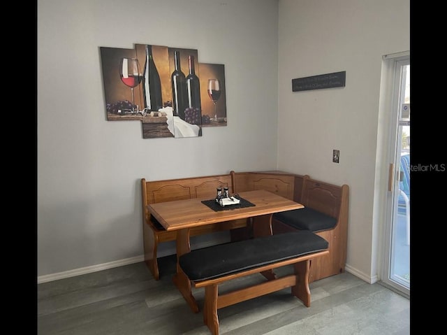 dining space featuring breakfast area, baseboards, and plenty of natural light