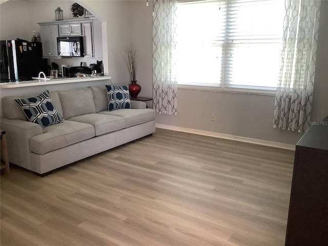 2057 Swift Rd, Oviedo, FL 32766 - living room featuring light wood-style floors and arched walkways
