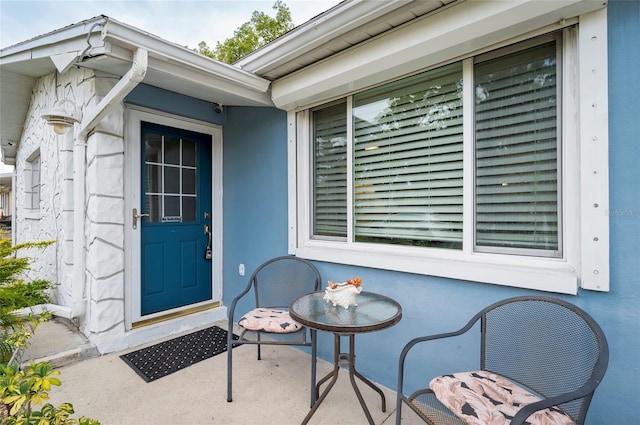 doorway to property featuring stucco siding