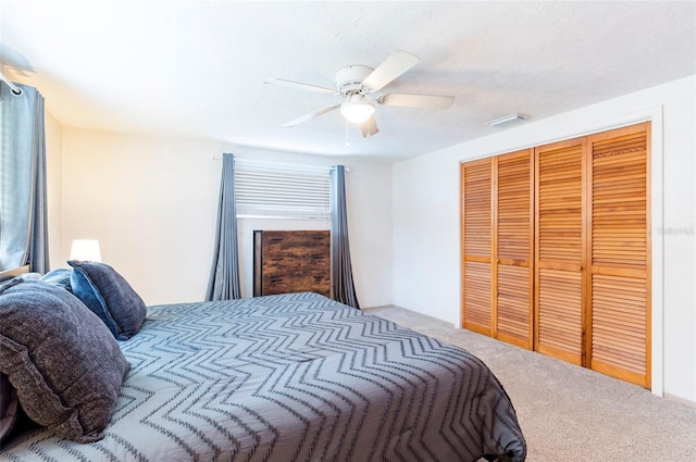 bedroom with carpet, a ceiling fan, and a closet