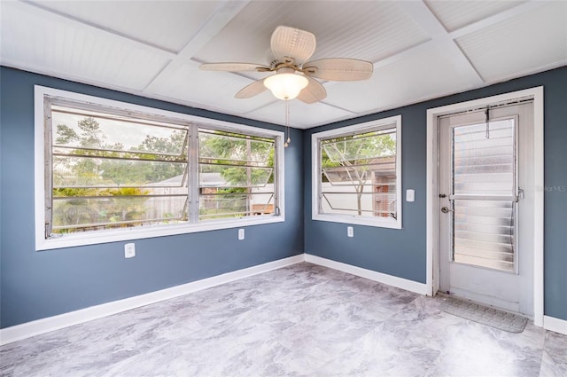 empty room with baseboards and a ceiling fan