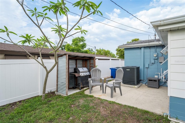 fenced backyard featuring central AC unit and a patio