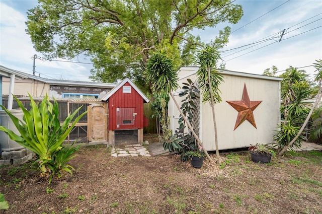 view of yard with exterior structure, an outbuilding, and fence