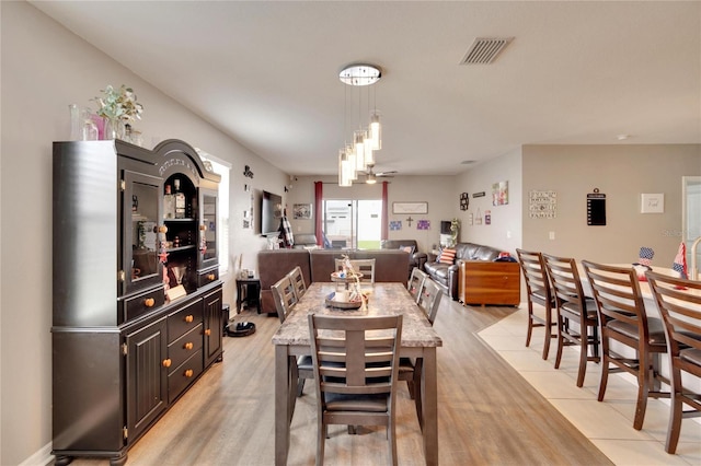 dining space featuring light wood-type flooring
