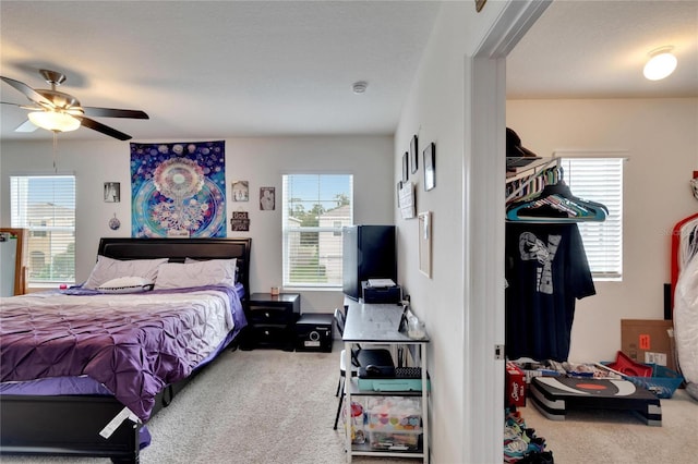 bedroom with carpet flooring, multiple windows, and ceiling fan
