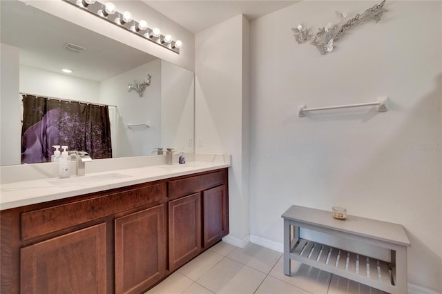 full bathroom with tile patterned floors, vanity, and baseboards