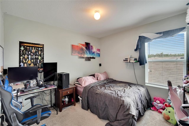 carpeted bedroom with a desk