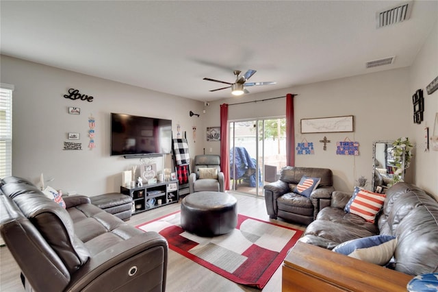 living area with ceiling fan and light wood-style floors