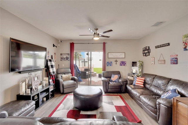 living area featuring light wood-type flooring and a ceiling fan