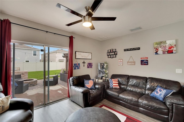 living room with wood finished floors and ceiling fan