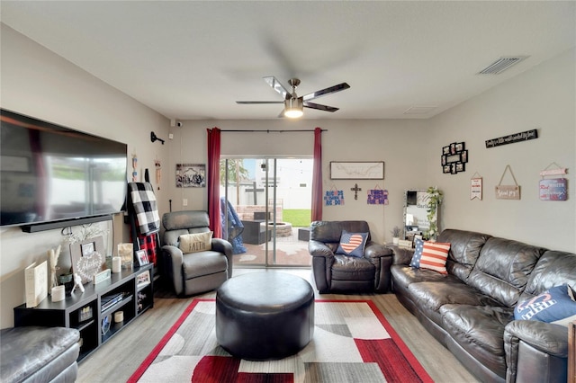 living room featuring light wood-type flooring and ceiling fan