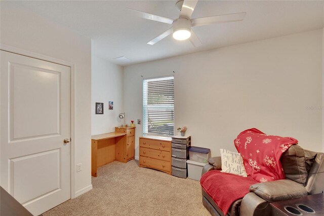 sitting room with light carpet, ceiling fan, and baseboards