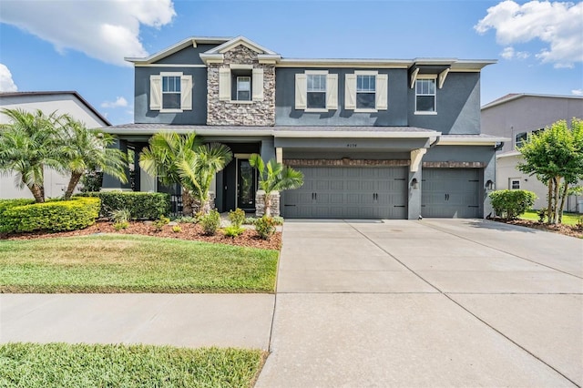 4094 Windcrest Dr, Wesley Chapel, FL 33544 - craftsman-style house with stone siding, driveway, a garage, stucco siding, and a front lawn
