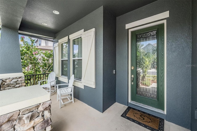 4094 Windcrest Dr, Wesley Chapel, FL 33544 - doorway to property with a porch and stucco siding