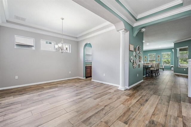 4094 Windcrest Dr, Wesley Chapel, FL 33544 - interior space with arched walkways, a notable chandelier, ornamental molding, and wood finished floors