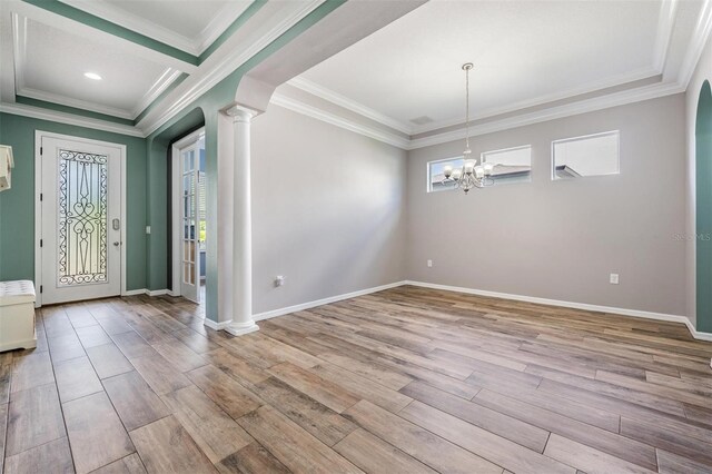 4094 Windcrest Dr, Wesley Chapel, FL 33544 - foyer entrance featuring crown molding, a chandelier, light wood-style flooring, and ornate columns
