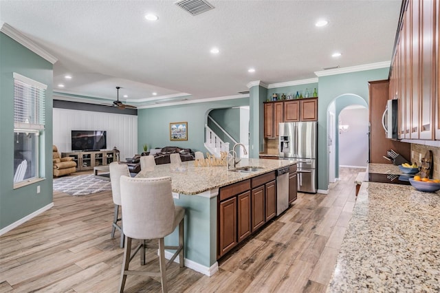 4094 Windcrest Dr, Wesley Chapel, FL 33544 - kitchen with ceiling fan, visible vents, a sink, arched walkways, and stainless steel appliances