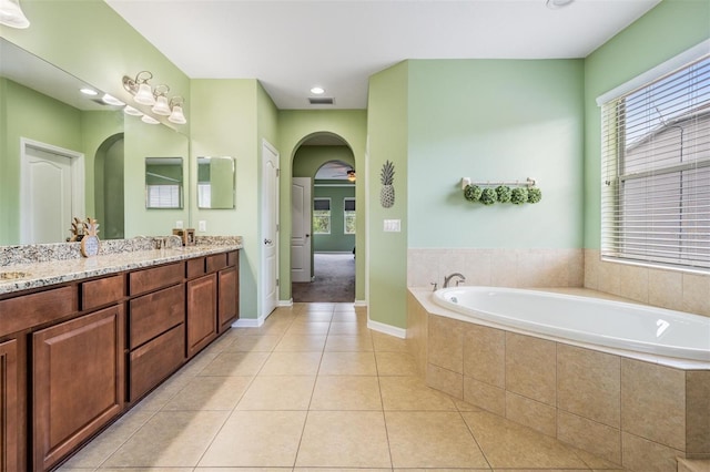 4094 Windcrest Dr, Wesley Chapel, FL 33544 - full bath with visible vents, a sink, tile patterned flooring, a garden tub, and double vanity