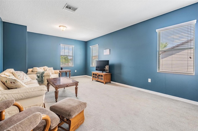 4094 Windcrest Dr, Wesley Chapel, FL 33544 - carpeted living area with a textured ceiling, visible vents, and baseboards