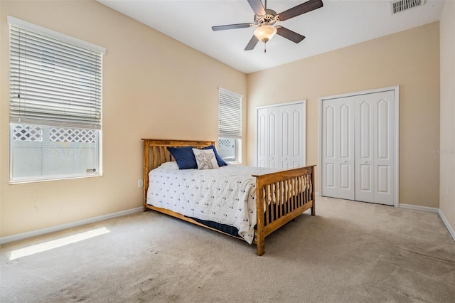 4094 Windcrest Dr, Wesley Chapel, FL 33544 - carpeted bedroom featuring two closets, baseboards, ceiling fan, and visible vents