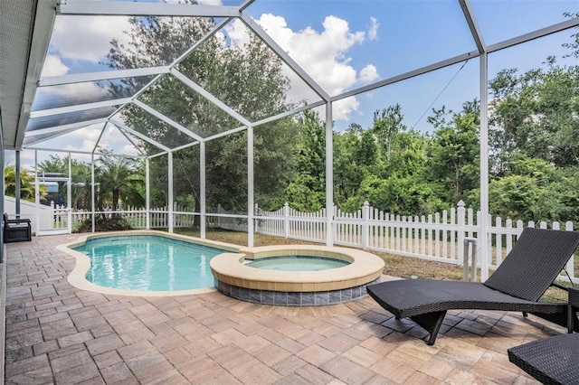 4094 Windcrest Dr, Wesley Chapel, FL 33544 - view of swimming pool featuring a patio area, a pool with connected hot tub, fence, and glass enclosure