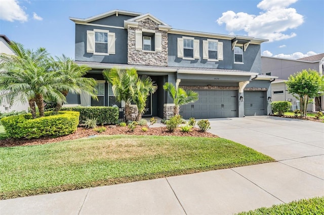 4094 Windcrest Dr, Wesley Chapel, FL 33544 - craftsman house featuring stone siding, stucco siding, and an attached garage
