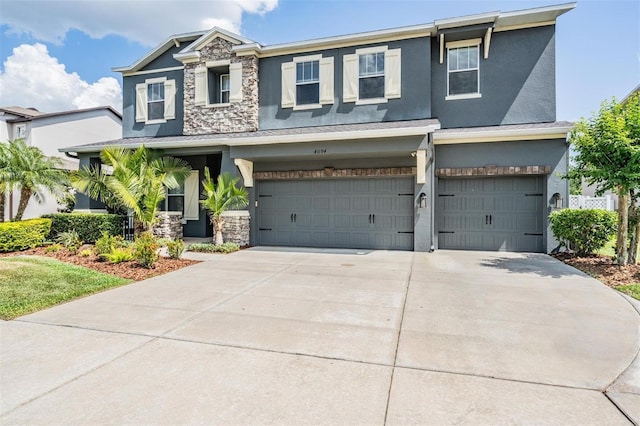 4094 Windcrest Dr, Wesley Chapel, FL 33544 - craftsman house featuring stone siding, stucco siding, driveway, and a garage