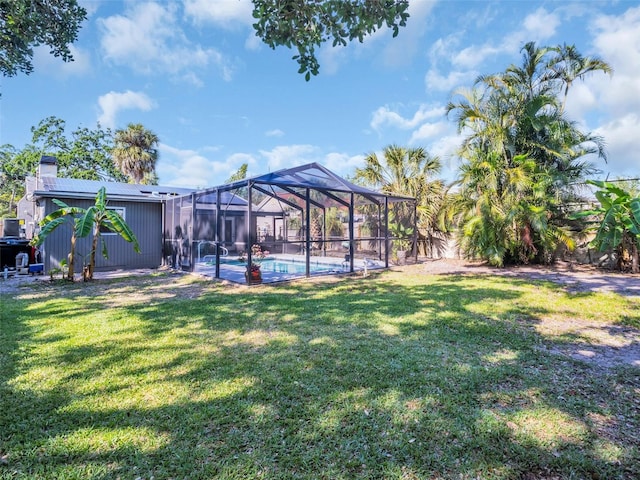 view of yard featuring an outdoor pool and a lanai