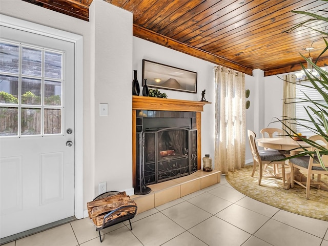 tiled living area with wooden ceiling and a fireplace