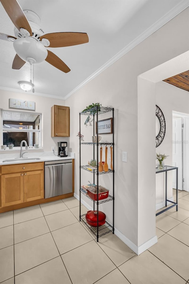 kitchen with a sink, crown molding, stainless steel dishwasher, ceiling fan, and light countertops