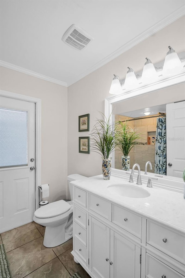 bathroom featuring toilet, vanity, ornamental molding, visible vents, and tile patterned floors