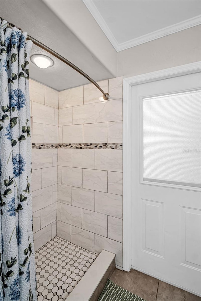 full bath featuring crown molding, tile patterned flooring, and a stall shower
