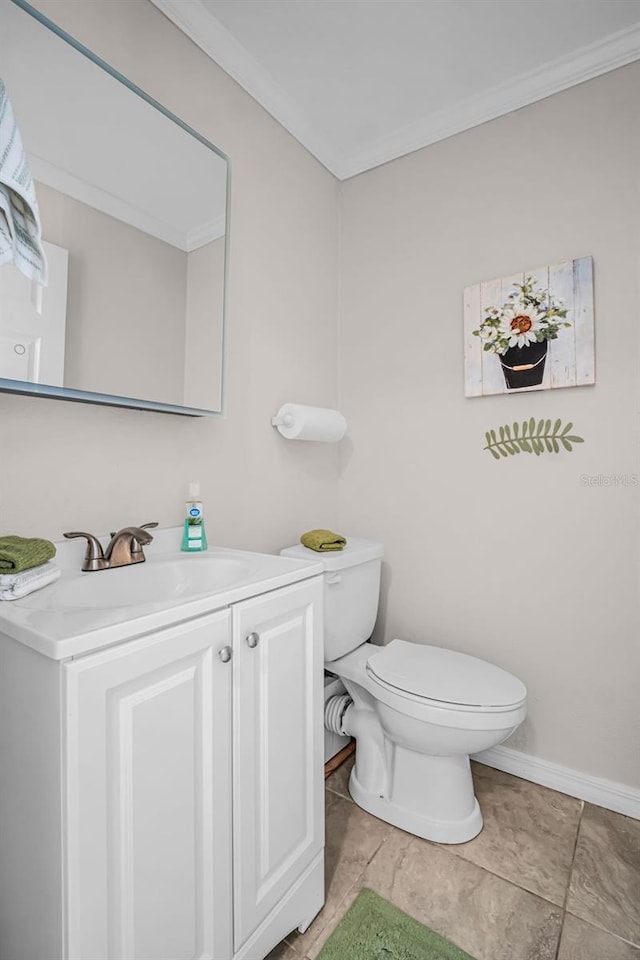 half bathroom with toilet, baseboards, vanity, and ornamental molding
