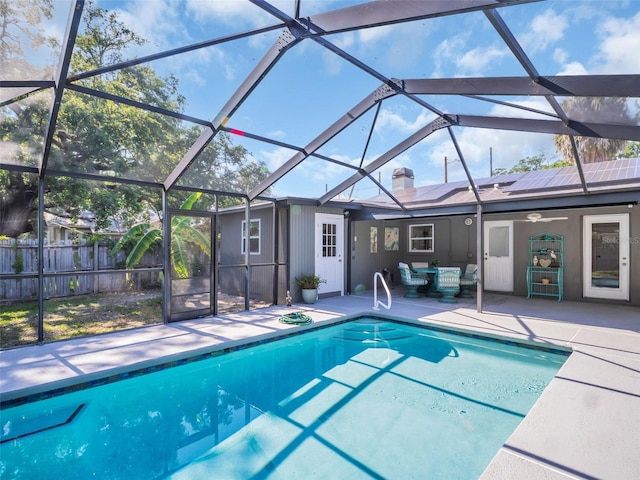 view of swimming pool featuring fence, a patio area, a fenced in pool, and glass enclosure