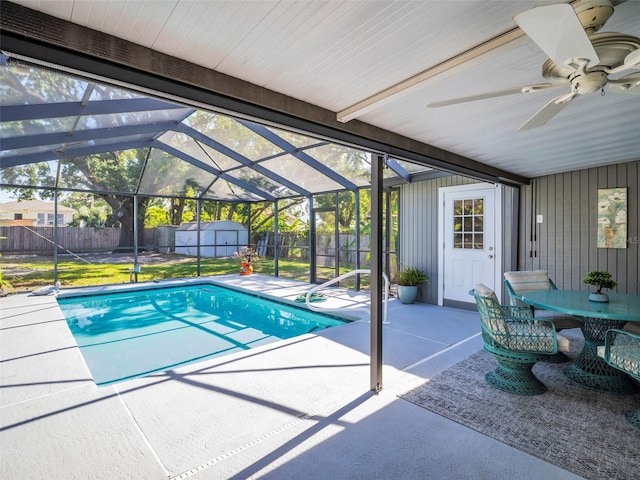 view of pool with a ceiling fan, an outbuilding, a storage unit, a fenced backyard, and a patio area