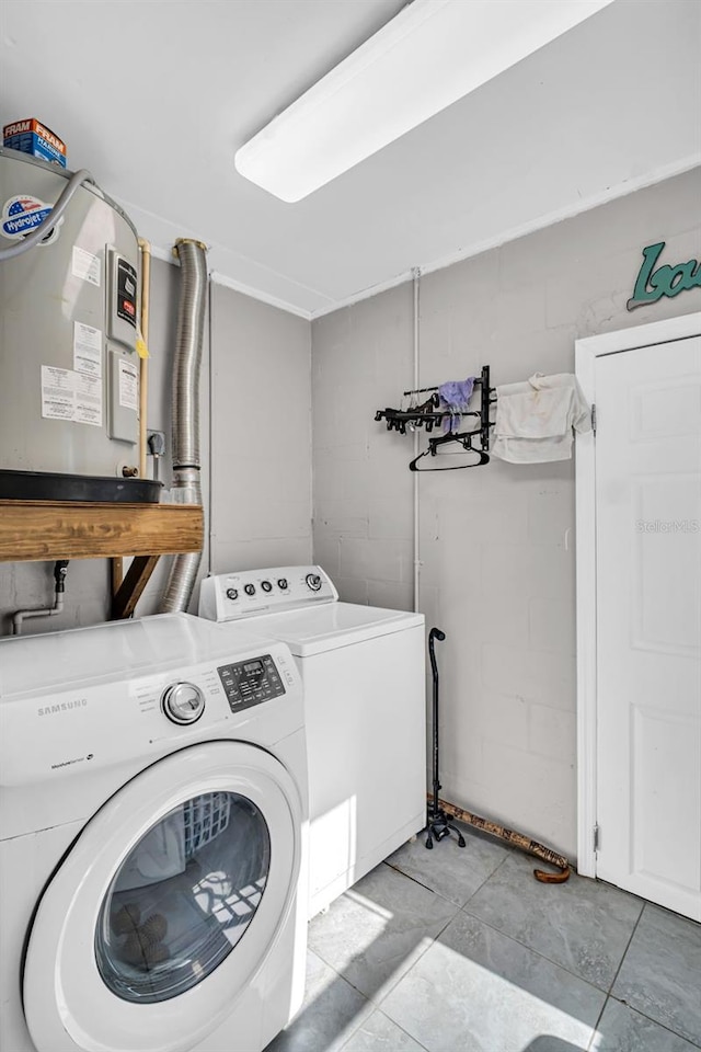 laundry area featuring laundry area, concrete block wall, and washer and dryer