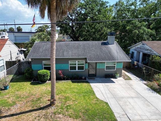 ranch-style house with a chimney, fence, stucco siding, a shingled roof, and a front yard