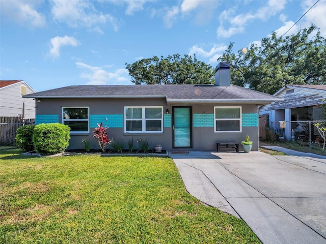 ranch-style home with roof with shingles, fence, stucco siding, a front lawn, and a chimney