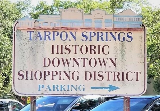 community sign featuring uncovered parking