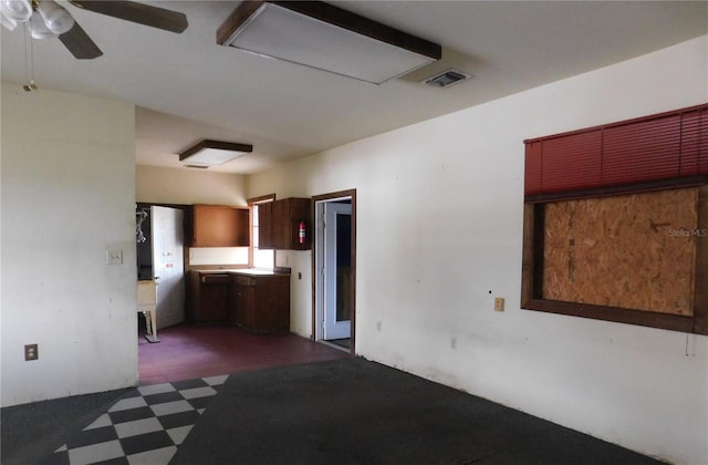 interior space with tile patterned floors, ceiling fan, and visible vents