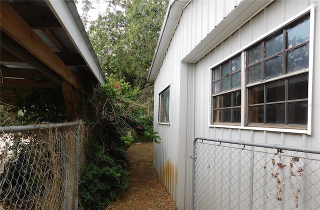 view of property exterior with fence and board and batten siding