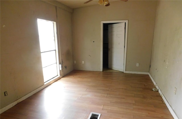 spare room with visible vents, light wood-style flooring, and a healthy amount of sunlight
