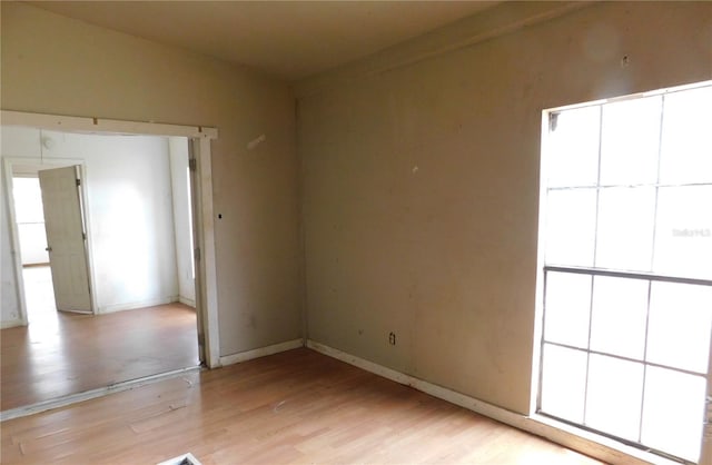unfurnished room featuring light wood finished floors and baseboards