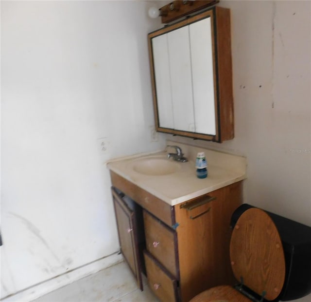 half bath featuring toilet and vanity