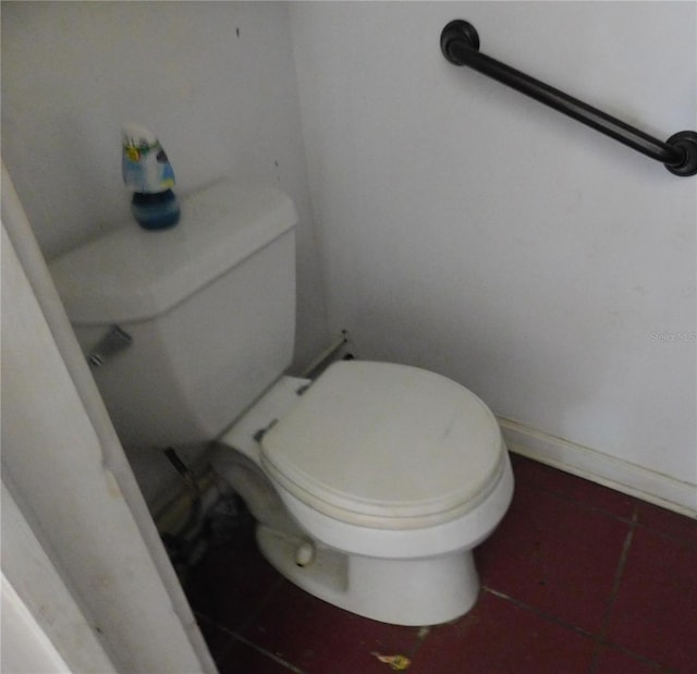 bathroom with toilet and tile patterned flooring