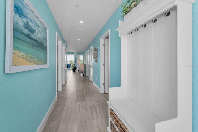 mudroom with baseboards and recessed lighting